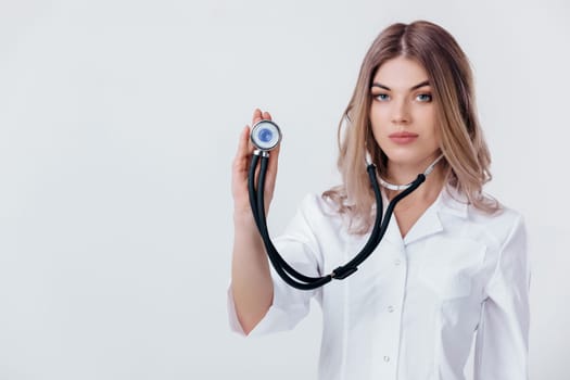 Medical physician doctor woman in white coat with stethoscope listening. focus on stethoscope