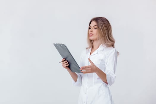 Medical physician doctor woman in white coat holds folder with documents and talking to someone