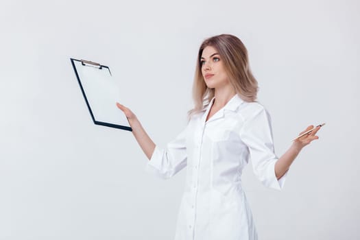 Medical physician doctor woman in white coat holds folder and spreads her arms to the side