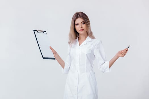 Medical physician doctor woman in white coat holds folder and spreads her arms to the side. doctor looks at camera