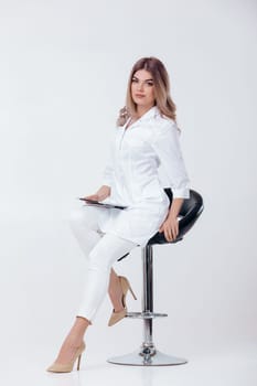beautiful young doctor in white coat with digital tablet