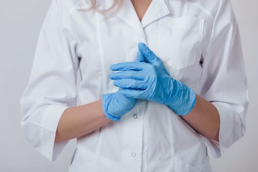 Woman doctor hands in medical latex blue gloves, close-up