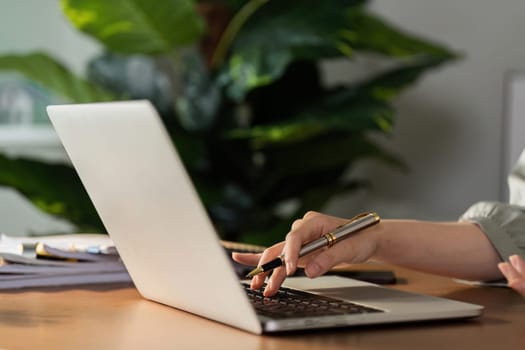 business woman hands typing on keyboard, working online in modern office.