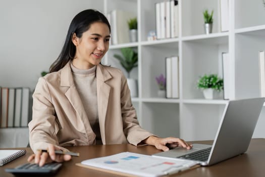 businesswoman working with documents and laptop, worker paperwork calculates financial and happy with success and result of achievement.