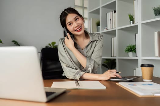 Business woman talking on mobile with client, business partner for business meeting.