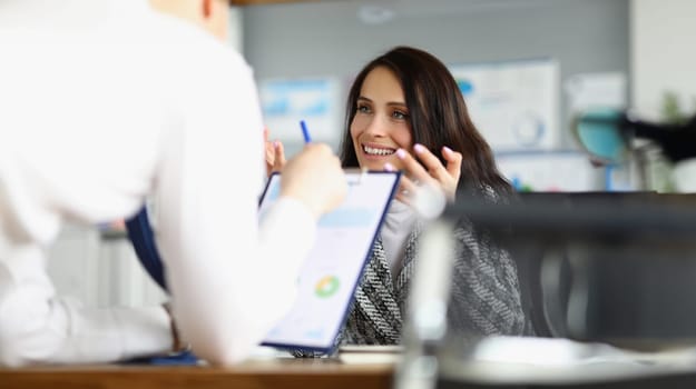 Business people discussing documents with graphs in office. Business partnership concept