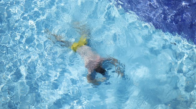 Man lying at bottom of swimming pool top view. Drowning aid concept