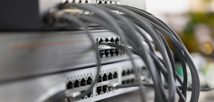 Optical mains cables connected to main server closeup. Telecommunication concept