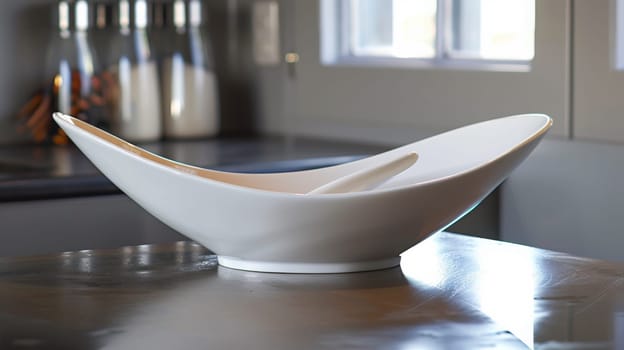 A white bowl sitting on top of a table in front of some bottles