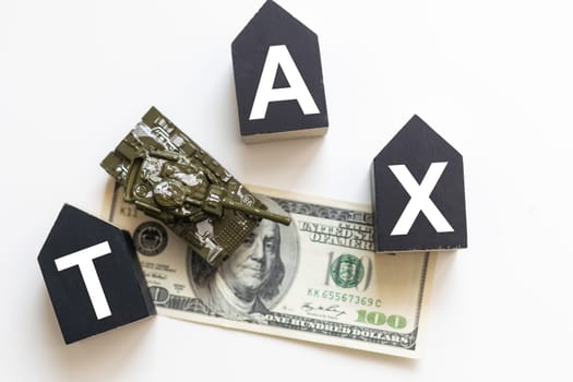 Tax text in wooden cubes and tax or vat form documents to complete Individual income tax return form for payment to Government. Calculation tax return in 2022 to 2023. High quality photo