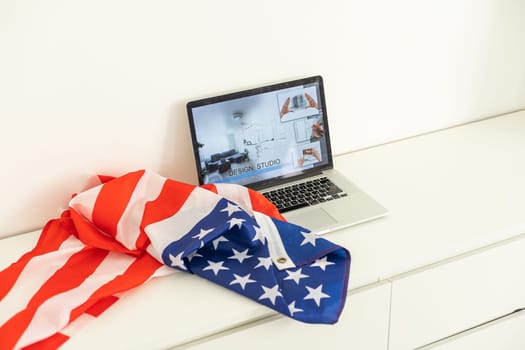 booking on the computer. laptop and american flag. High quality photo