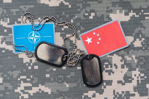 army blank, dog tag with flag of nato and vietnam on the khaki texture background. military concept. High quality photo