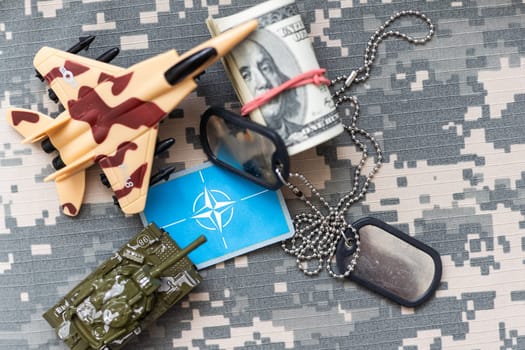 Military ID tags with chain on camouflage uniform, toned in colors of Ukrainian flag war. High quality photo