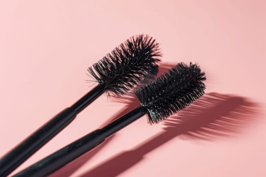 Black eyelash brushes on a pink background. Women's cosmetics. Face Makeup.