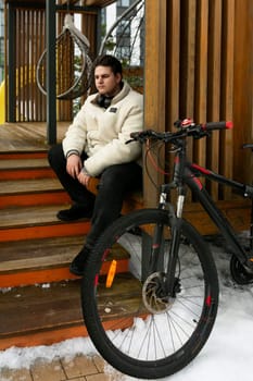 Lifestyle concept, young man stopped while cycling.