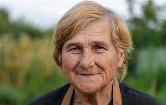 Elderly woman portrait in the garden. selective focus. Nature.