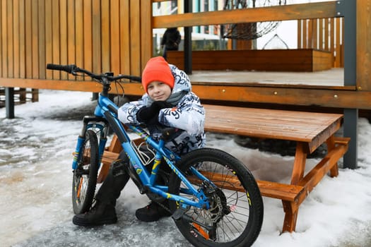 Boy riding a bike during winter holidays.