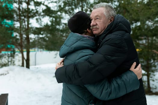 Happy elderly couple walking in the park and confessing their feelings.