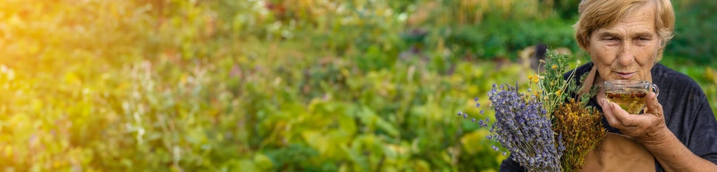 An elderly woman brews herbal tea. Selective focus. Drink.