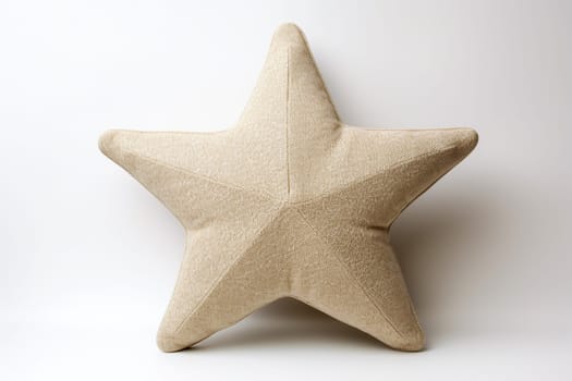 Beige star-shaped cushion against a white backdrop