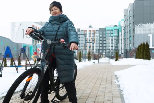 Mature European woman extends longevity and rides a bicycle.