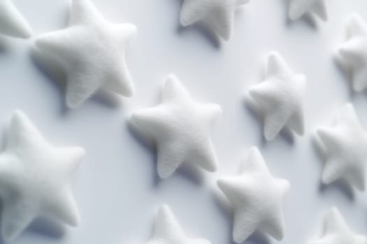 Uniform white star shapes arranged on a plain background