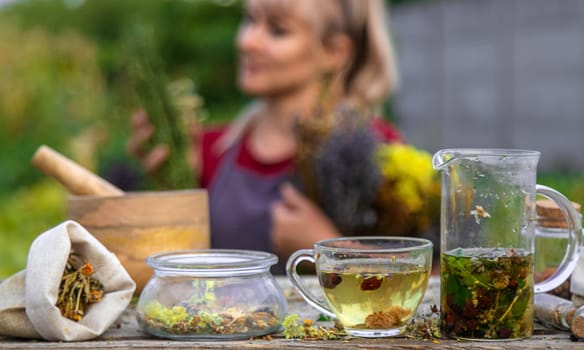 woman brews herbal tea. Selective focus. Nature.