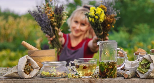 woman brews herbal tea. Selective focus. Nature.