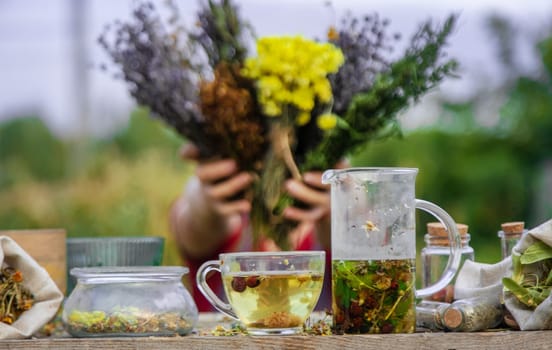 woman brews herbal tea. Selective focus. Nature.