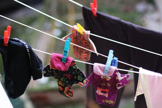 Embrace eco-friendly menstruation with these empowering images of reusable period pads hanging out to dry.