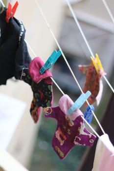 Embrace eco-friendly menstruation with these empowering images of reusable period pads hanging out to dry.