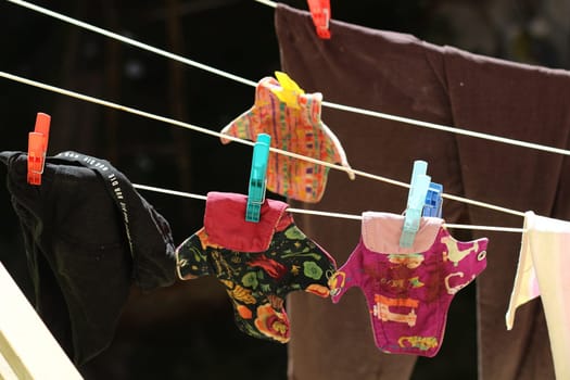 Embrace eco-friendly menstruation with these empowering images of reusable period pads hanging out to dry.