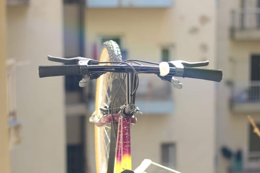 Embrace the urban lifestyle with this picturesque scene of a bicycle resting peacefully on a balcony