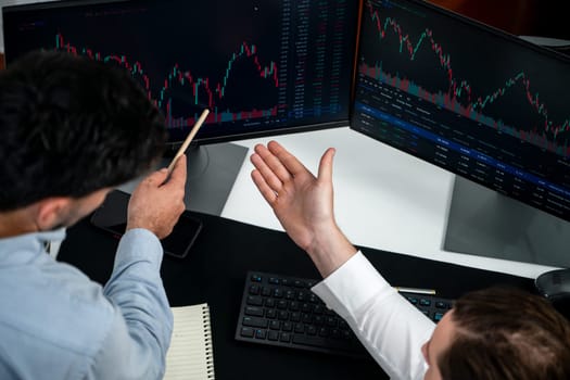 Business professional brokers discussing stock market on pc screen in real time, analyzing dynamic exchange rate database graph or interesting unit investment for trading in valued growth. Sellable.