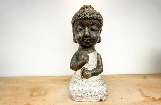 Small statue decorations for table and interior, little buddha statue modern simplistic house environment with several pottery and wooden table