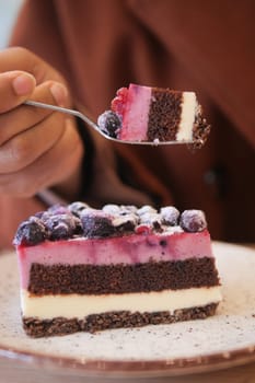 cutting A piece of purple velvet cake with cream .