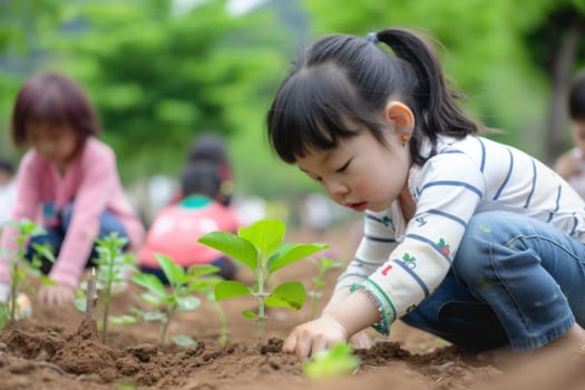 Toddler girl learning to plant little trees for environment conservation.Children lean farming to protect the ecosystem.