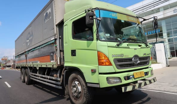 trucks making local commercial delivery at urban city and on the city streets in asia logistical transport system in Indonesia