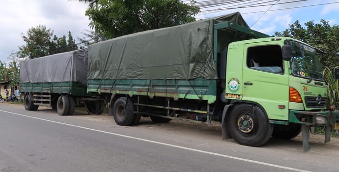 trucks making local commercial delivery at urban city and on the city streets in asia logistical transport system in Indonesia