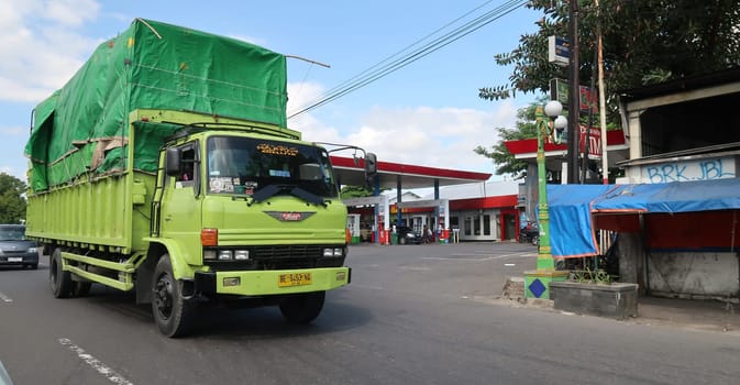 trucks making local commercial delivery at urban city and on the city streets in asia logistical transport system in Indonesia