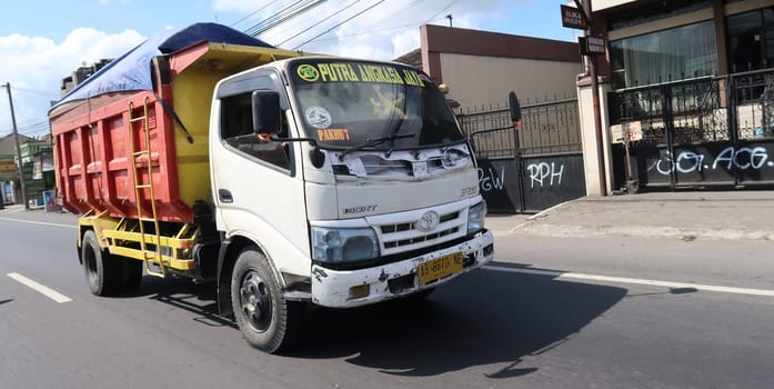 trucks making local commercial delivery at urban city and on the city streets in asia logistical transport system in Indonesia