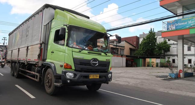 trucks making local commercial delivery at urban city and on the city streets in asia logistical transport system in Indonesia