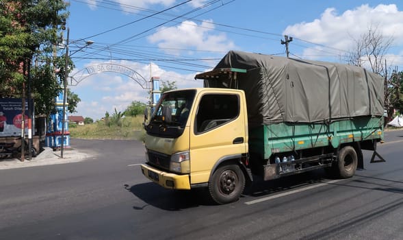 trucks making local commercial delivery at urban city and on the city streets in asia logistical transport system in Indonesia