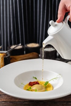 Ravioli consomme on a white porcelain plate. Healthy eating concept