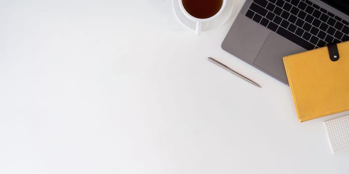 Top view with copy space for your text. Laptop computer and cup of coffee on white background.