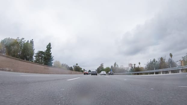 Amidst a rainy winter day, driving on HWY 134 near Los Angeles, California, captures the atmosphere through raindrop-covered lenses, adding a unique and moody perspective to the journey.