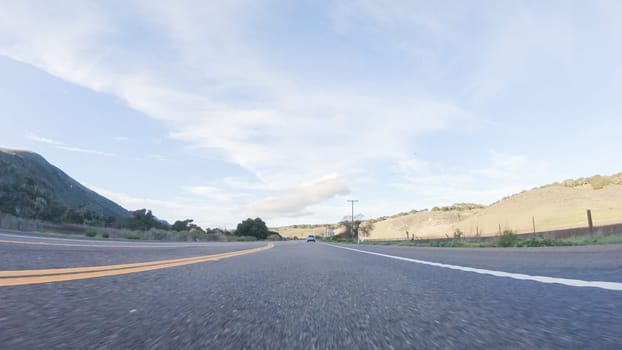 Basking in the beauty of a sunny winter day, driving on HWY 1 near Las Cruces, California offers stunning views of the picturesque coastal landscape against a backdrop of clear blue skies.