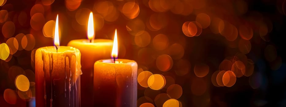 Three lit candles with a soft, golden bokeh effect creating a cozy atmosphere