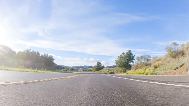 Basking in the beauty of a sunny winter day, driving on HWY 1 near Las Cruces, California offers stunning views of the picturesque coastal landscape against a backdrop of clear blue skies.