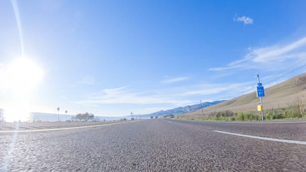 During the day, driving on HWY 101 near Arroyo Quemada Beach, California, offers scenic views of the surrounding coastal landscape.